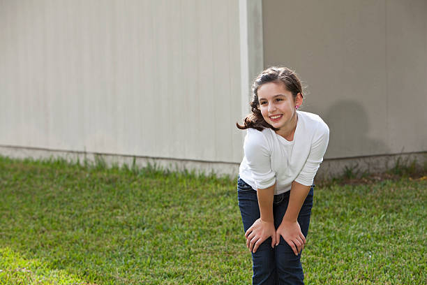 Girl (10 years, mixed race Hispanic/Caucasian) standing outdoors.