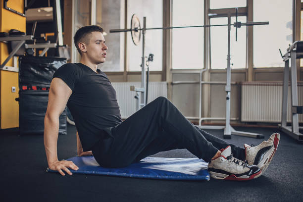 istock Man exercising in gym 1808111846