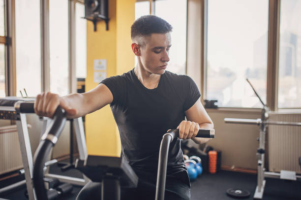 istock Young man exercising in gym 1808115500