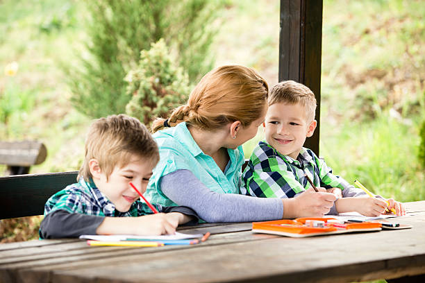 istock Mother and sons drawing outdoors 180811683