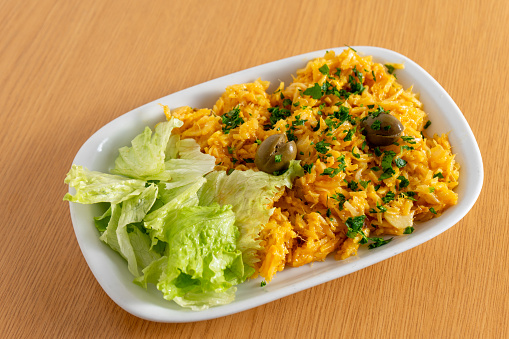 Classic Portuguese dish, Bacalhau à Brás, served in a cozy snack bar – a delicious blend of shredded cod, eggs, and crispy potatoes.