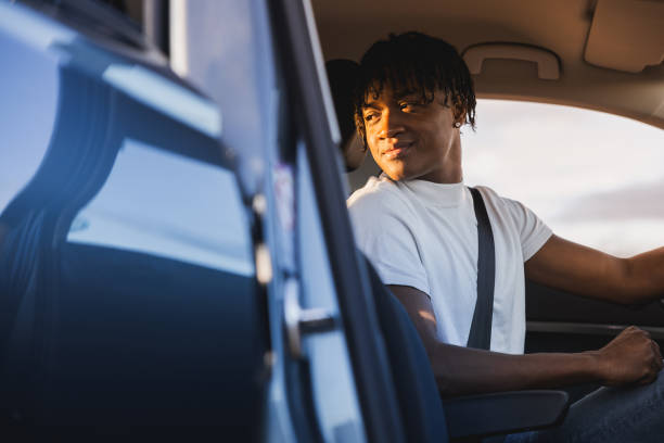 istock Man inside the car, getting ready for the trip, looking back to make sure his son is properly fastened with the seatbelt. 1808118748