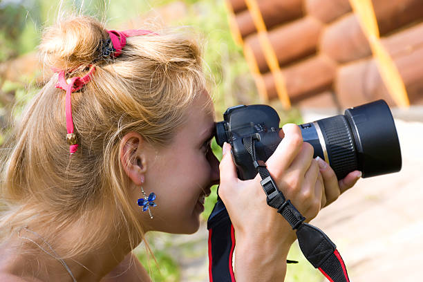 istock young woman with a camera 180811913