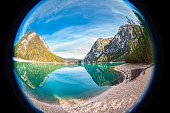 Turquoise colored lake in the Dolomites through a fisheye lens