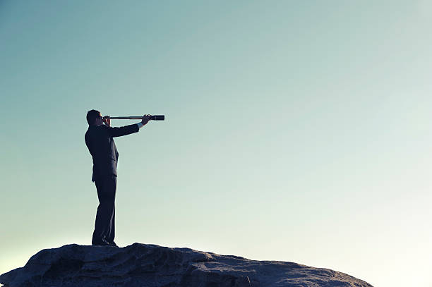 istock Businessman looking to the future with telescope 180812163
