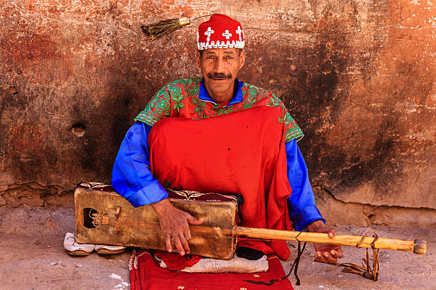 Street musician in Marrakesh, Morocco "Moroccan street musician in traditional costume on Djemaa el Fna square, Marrakech, Morocco. Djemaa el Fna is a heart of Marrakesh's medina quarter." berber stock pictures, royalty-free photos & images