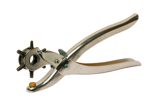 Tailoring accessories. Closeup of a old adjustable Steel punch pliers or hole punch tool isolated. Clipping path. Tools from tailor, saddler or cobbler.