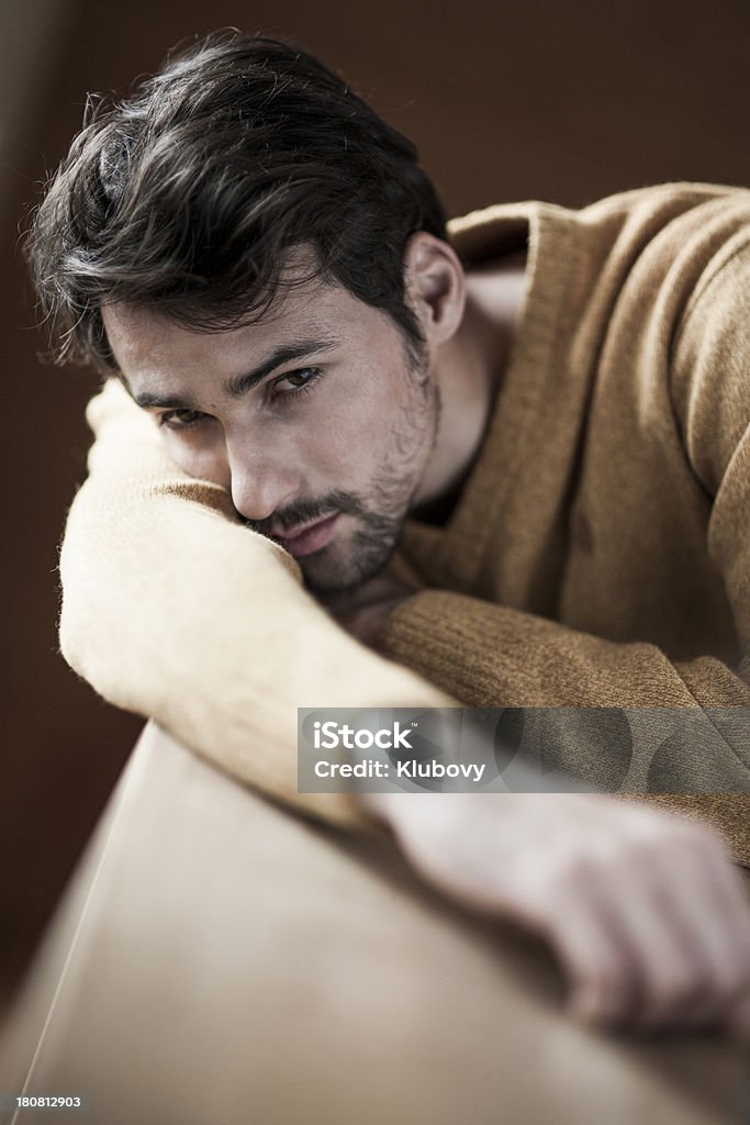 Portrait of a young man Portrait of a pensive young man leaning on table. 20-29 Years Stock Photo