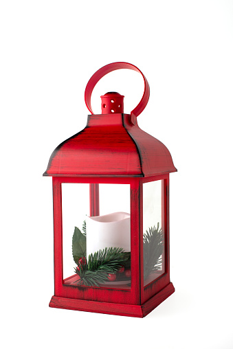 Red Christmas lantern with white candle with pine branches  on a white background