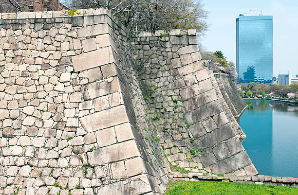 istock Old stone wall and modern office building in Osaka 180813233