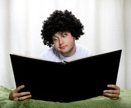 funny man looking in book with big eyes,