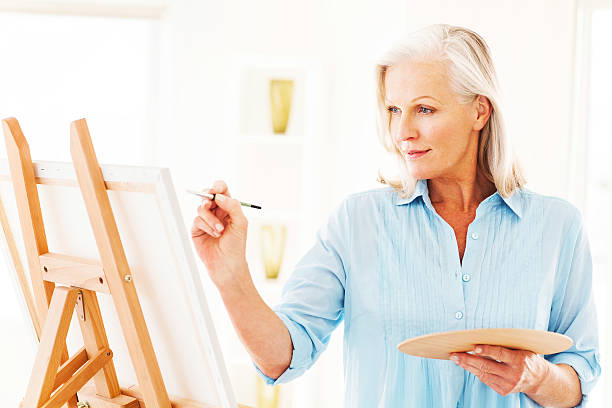 istock Senior Woman Painting On Canvas 180813705