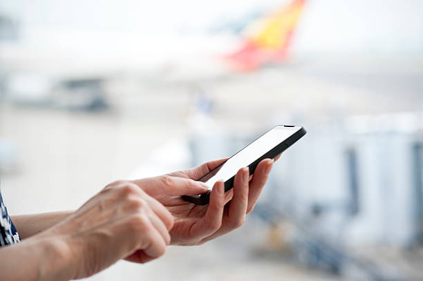 istock Lady using smartphone at the airport 180814686