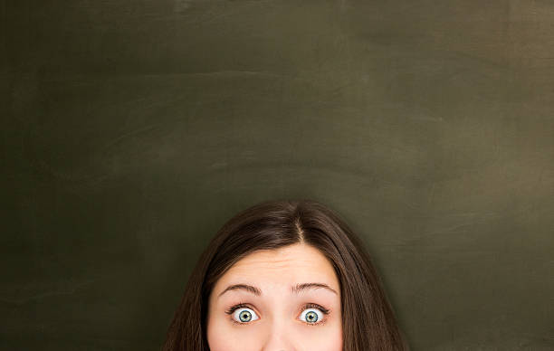 istock Woman in front of empty blackboard. 180814933