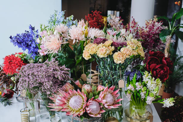 istock Assorted blooming colorful flowers in glass vases 1808149673