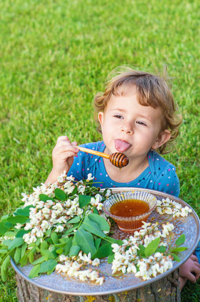 istock The child eats honey in the garden. Selective focus. 1808150742