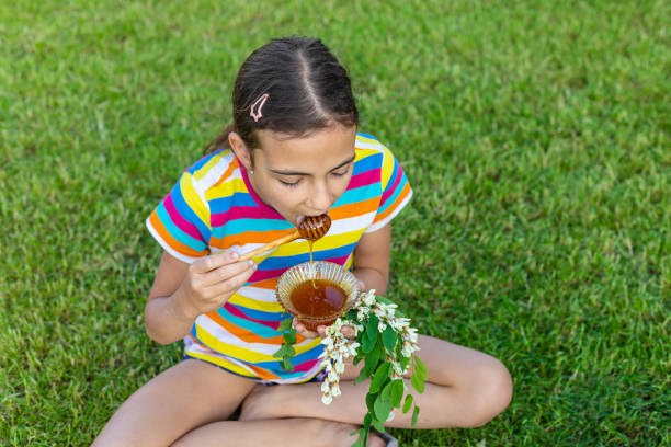 istock The child eats honey in the garden. Selective focus. 1808150752