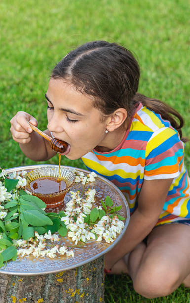 istock The child eats honey in the garden. Selective focus. 1808150754
