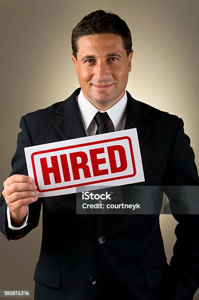 Businessman Holding Hired Sign Stock Photo - Download Image Now - Human Resources, Poster, Achievement