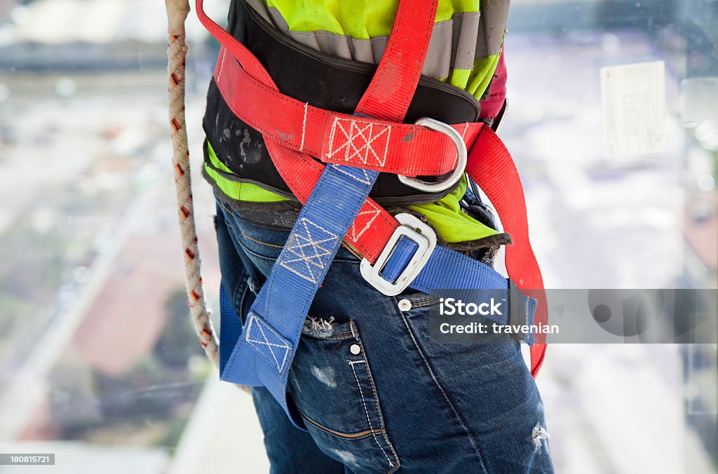 Construction worker on side of building overlooking street Construction worker Adult Stock Photo