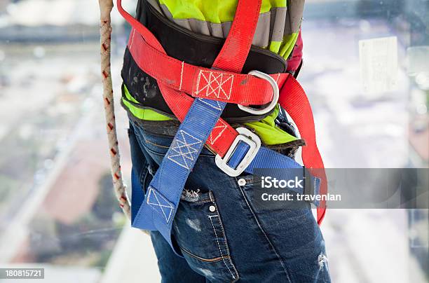Construction Worker On Side Of Building Overlooking Street Stock Photo - Download Image Now