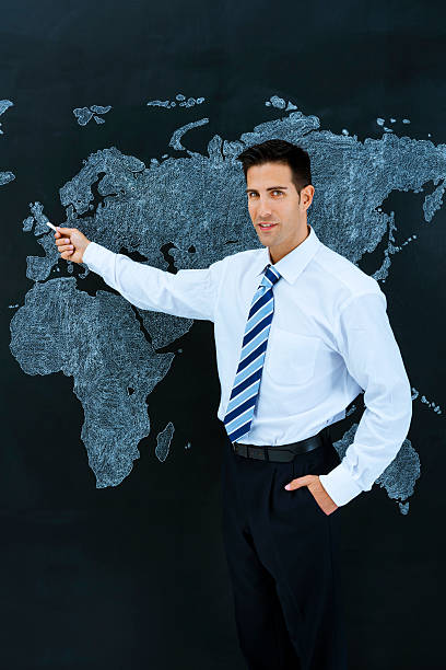 istock Businessman pointing world map: London, UK 180815747