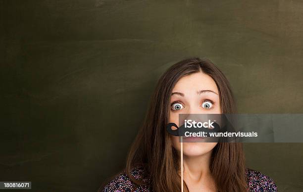 Hipster Girl With Mustache In Front Of Empty Blackboard Stock Photo - Download Image Now