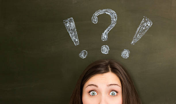 istock Thinking young woman with question mark on blackboard 180816131