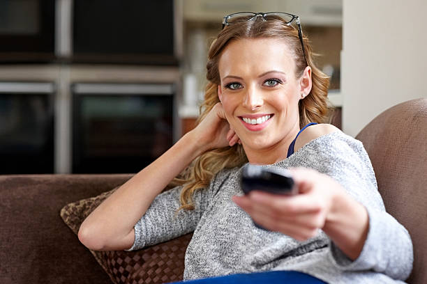 istock Young woman changing television channels 180816375