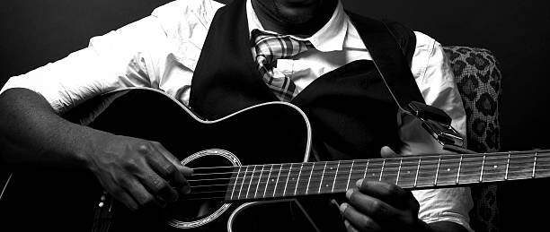 istock Old Black Blues Guitarist Playing Acoustic 180816411