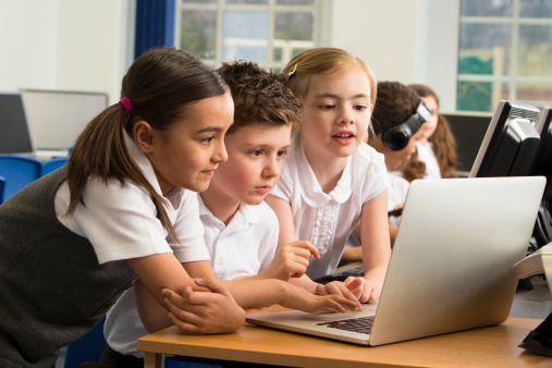 Preschool children looking on a laptop