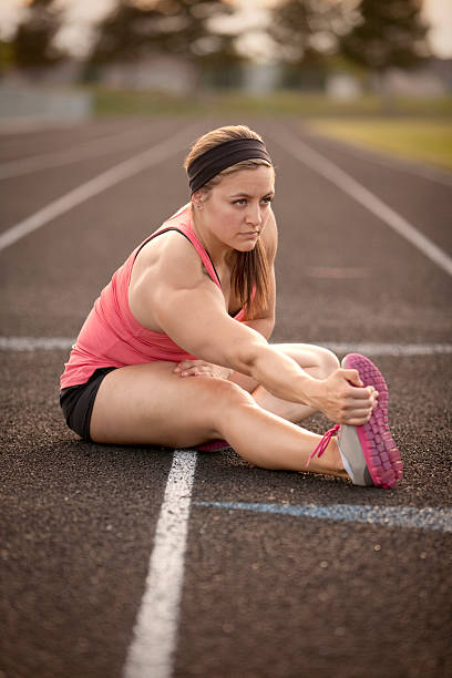 istock Woman stretching on a track at sunset 180817067