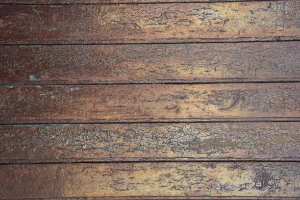 Old paint cracking in wooden door, texture with light