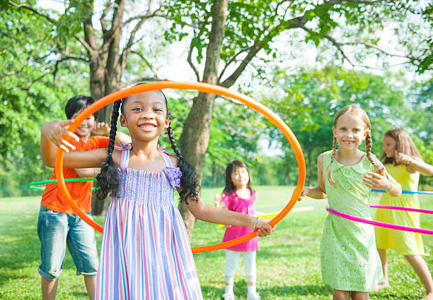 Multiracial kids playing hoops outside