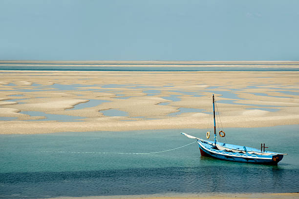 Boat floating on tropical turquoise water. Mozambique stock photo