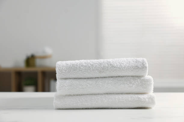 istock Stacked bath towels on white table indoors 1808172018