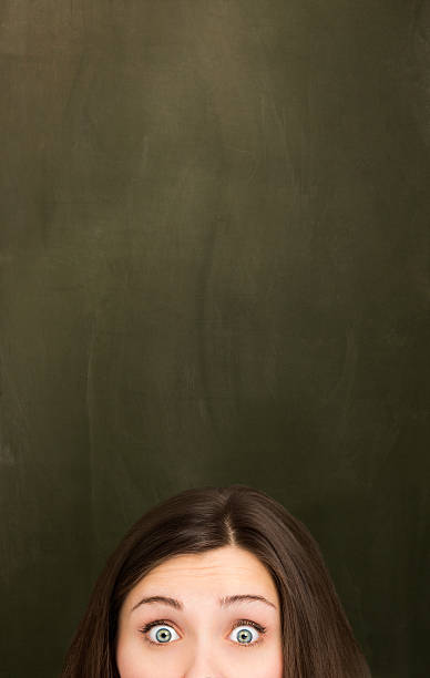 istock Woman in front of empty blackboard. 180817303