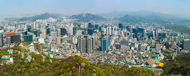 Aerial panoramic vista across the skyscrapers and landmarks, mountain parks and crowded suburbs of central Seoul, South Korea. ProPhoto RGB profile for maximum color fidelity and gamut.