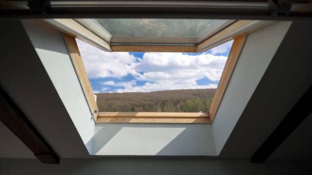 istock View from the open window at attic on blue sky with clouds 1808180443