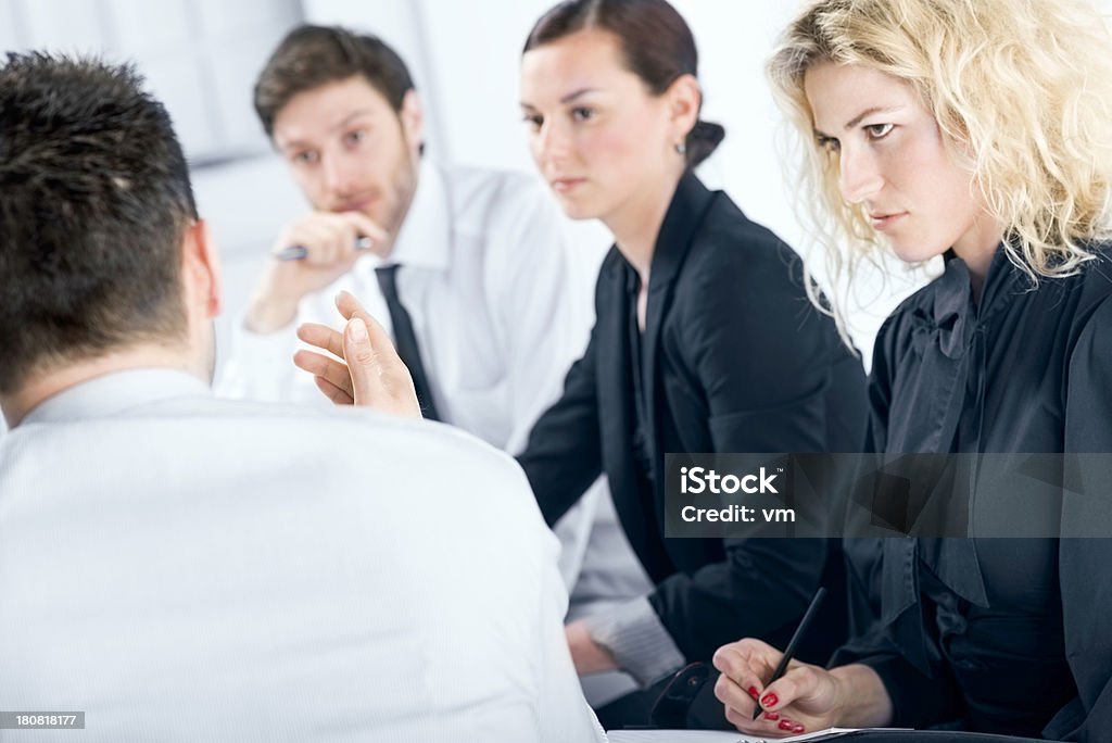 Manager explaining strategy to his team "Four businesspeople sitting in the office, focus on managers hand." 30-39 Years Stock Photo