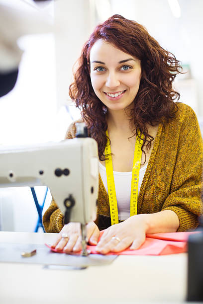 istock Smiling fashion designer sewing 180818320
