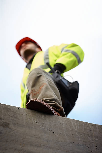 istock Young male construction worker standing at site 180818835