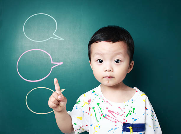 istock Cute child in front of the blackboard 180818864