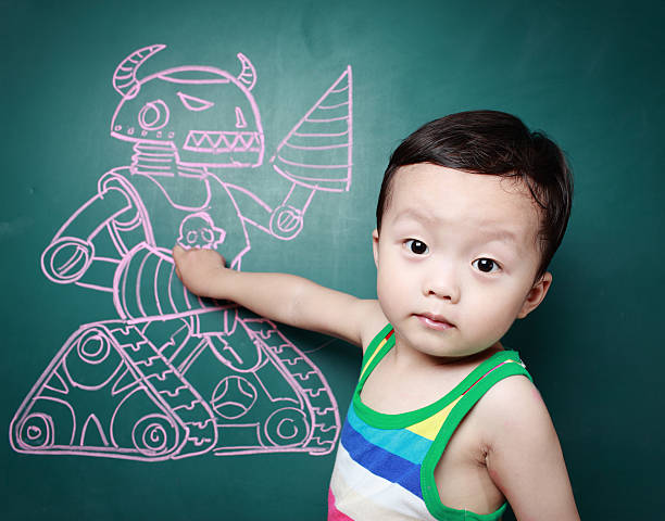 istock Cute child in front of the blackboard 180818955