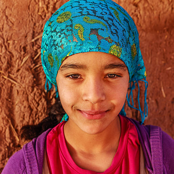 Beautiful Muslim girl in Moroccan kasbah "Beautiful Muslim girl in Moroccan Village near Ouarzazate, Morocco, Africa" moroccan girl stock pictures, royalty-free photos & images