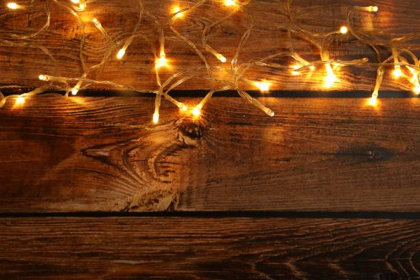istock Glowing festive lights on wooden background, top view. Space for text 1808195215