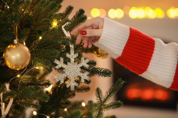 istock Woman decorating Christmas tree at home, closeup 1808195759