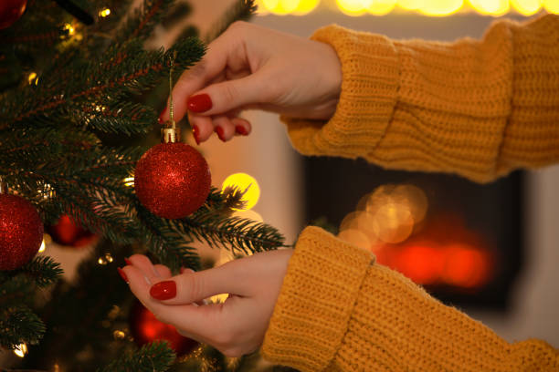 istock Woman decorating Christmas tree at home, closeup 1808195769