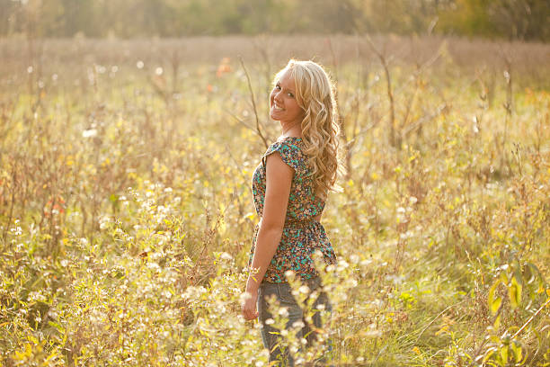 istock Pretty Young Blonde Girl Standing In A Field 180819620