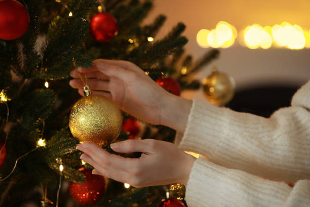 istock Woman decorating Christmas tree at home, closeup 1808196292